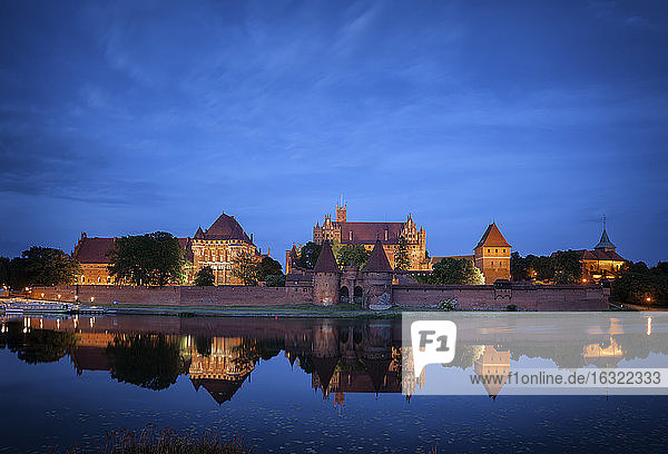 Poland Malbork Castle at River Nogat at night