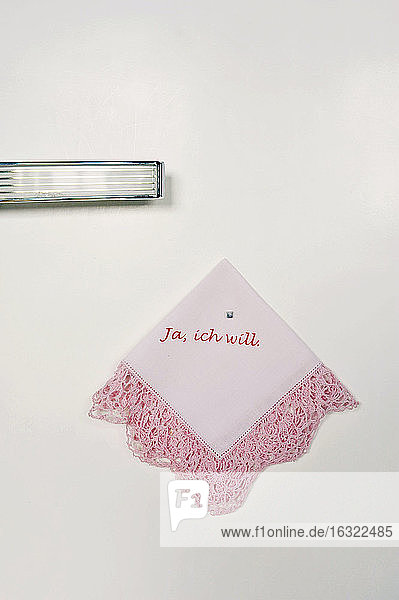 Printed old handkerchief hanging on wall