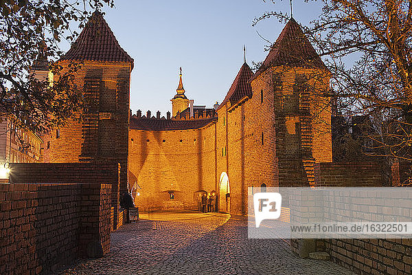 Poland Warsaw view to lighted Barbican city fortification at evening twilight