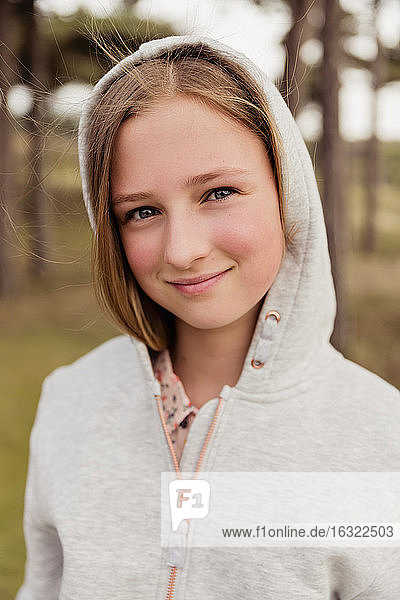 Portrait of smiling girl wearing hoodie