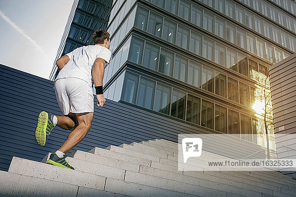 Sportsman jogging upstairs