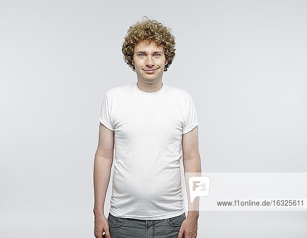 Portrait of smiling blond man wearing white t-shirt