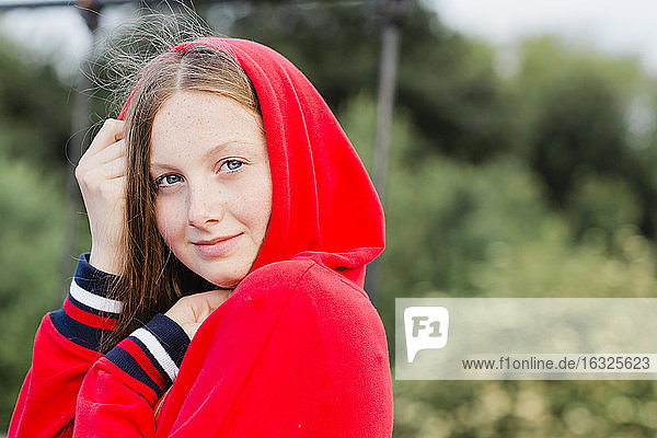Portrait of teenage wearing red hoodie sweater