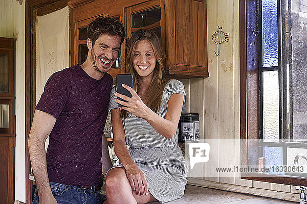 Young couple making video call with smartphone