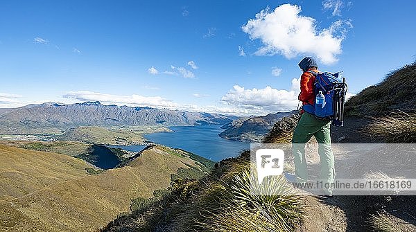 Hiker on the Ben Lomond trail  views of Lake Wakatipu and The Remarkables  Southern Alps  Otago  South Island  New Zealand  Oceania