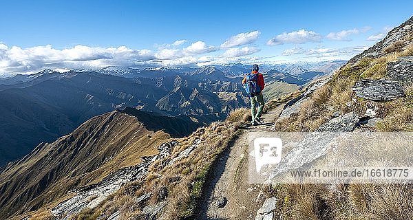 Hiker on the hiking trail to Ben Lomond  views of mountain ranges  Southern Alps  Otago  South Island  New Zealand  Oceania