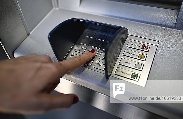 Frau tippt Geheimzahl am Geldautomat einer Sparkasse ein  Waiblingen  Baden-Württemberg  Deutschland  Europa
