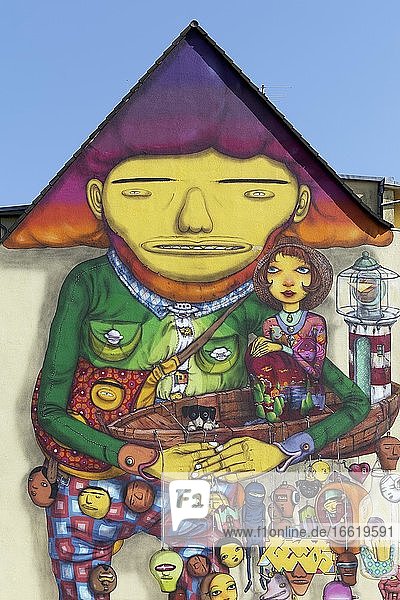 Happy giant in a play suit surreal figure mural of the Brazilian streetart artist duo Os Gemeos Düsseldorf North Rhine-Westphalia Germany Europe