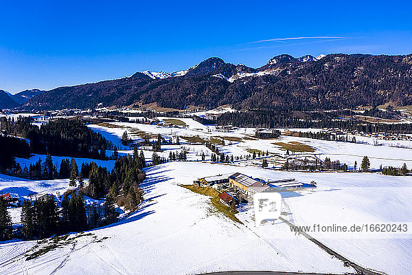Austria  Tyrol  Kossen  Helicopter view of mountain village in snow-covered Leukental valley