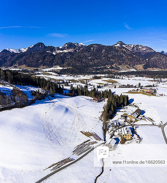 Austria  Tyrol  Kossen  Helicopter view of mountain village in snow-covered Leukental valley