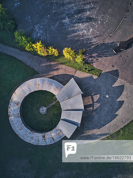 Directly above view of open-air theater with long shadow during sunset