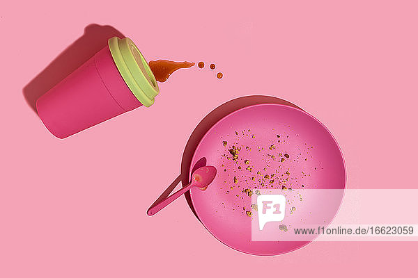 Pink coffee cup and dish against pink background