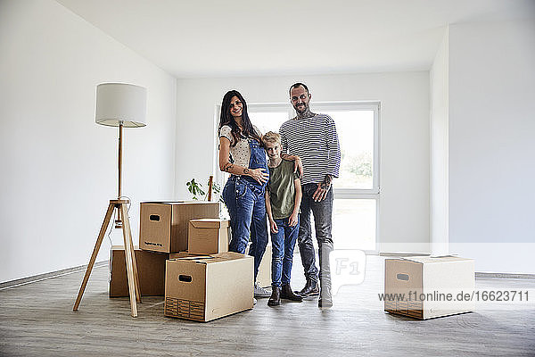 Family standing on floor of domestic room during move in day