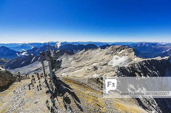 Austria  Tyrol  People waiting around ski lift in Wetterstein Mountains