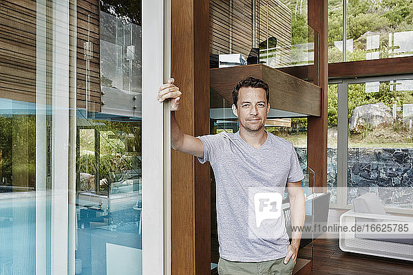 Mature man standing at home