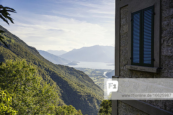 Italy Province of Sondrio Corner of building overlooking valley in Riserva Naturale Pian di Spagna e Lago di Mezzola