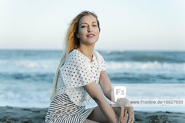 Beautiful woman sitting on beach