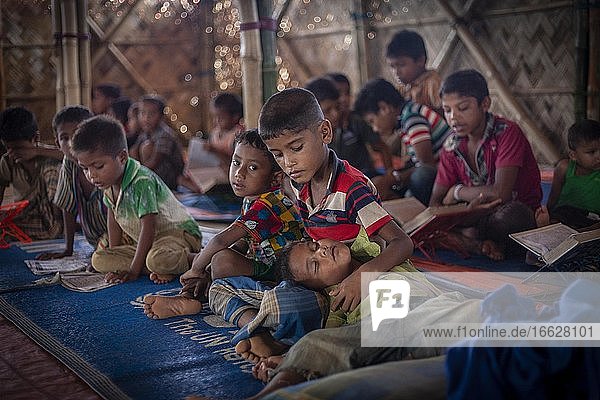 Children in a madrasah Koran school camp for Rohingya refugees from Myanmar Kutupalong Cox Bazar Bangladesh Asia