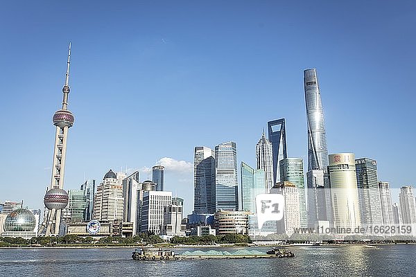 Pudong Area Special Economic Zone Municipality of Shanghai on the eastern bank of Huang Po River cargo ships left the Oriental Pearl Tower from the middle the Shanghai Tower Shanghai China Asia