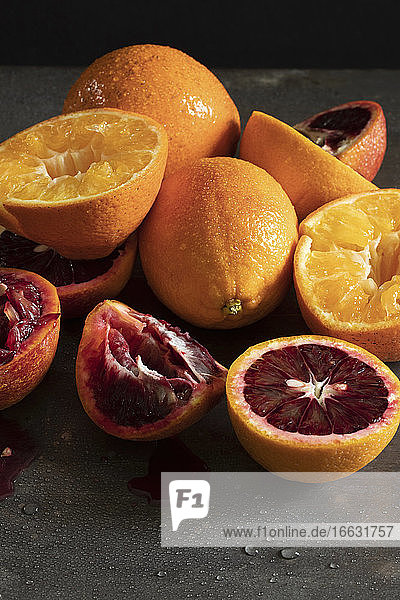 Oranges and blood oranges being juiced