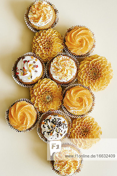 Cupcakes with vanilla cream cheese frosting decorated with sugar sprinkles in autumn style