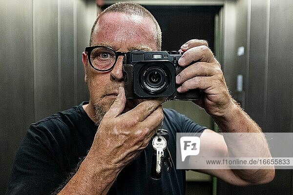 Berlin  Germany  Selfie / Self Portrait of a mature adult  caucasian man inside an elevator.