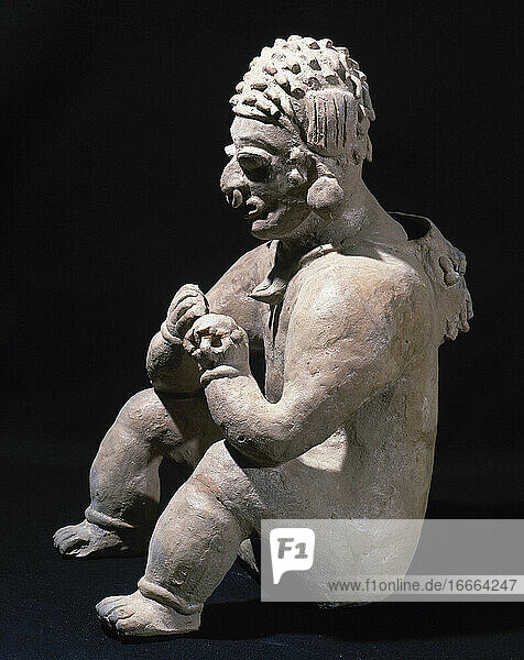 The Ancient Jama-Coaque Culture. Northern coast of Ecuador. 500 BC-500 AD. Ceramic figure. Seated man. Mold. Style chone. 37 x 20 cm. Private collection.
