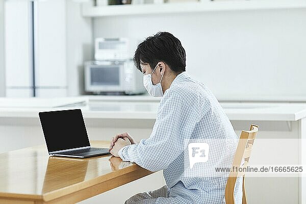 Sick Japanese man working from home