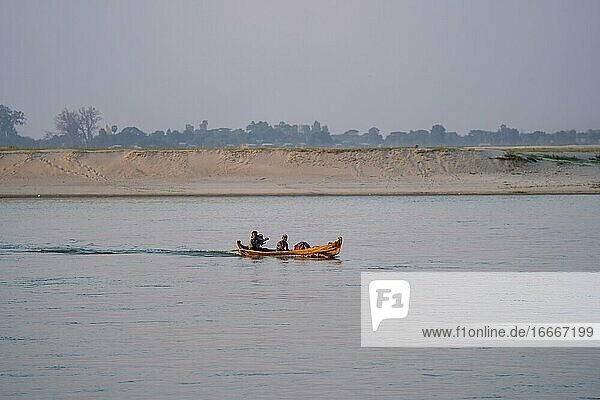 Boat with people goes on Irrawaddy River  Mingun  Myanmar  Asia