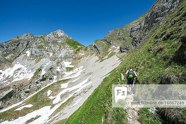 Hiker on a hiking trail  5-summit via ferrata  Roßkopf in the back  hiking at the Rofan Mountains  Tyrol  Austria  Europe