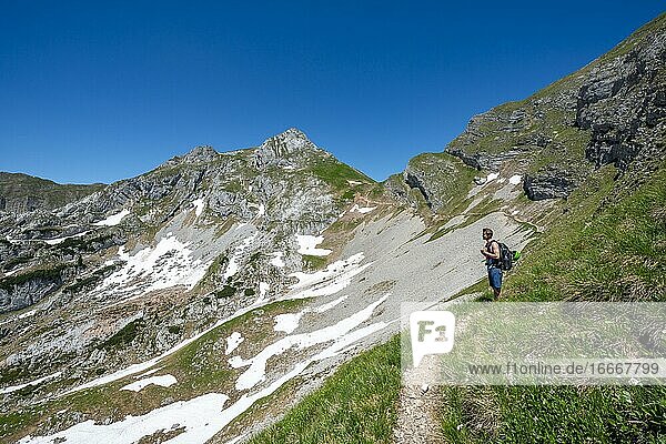 Hiker on a hiking trail  5-summit via ferrata  Roßkopf in the back  hiking at the Rofan Mountains  Tyrol  Austria  Europe