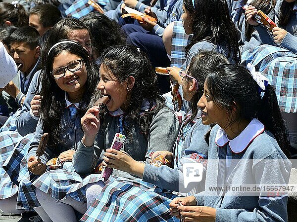 School class eating ice cream on the steps of the cathedral  Catedral Metropolitana  Quito  Pichincha Province  Ecuador  South America