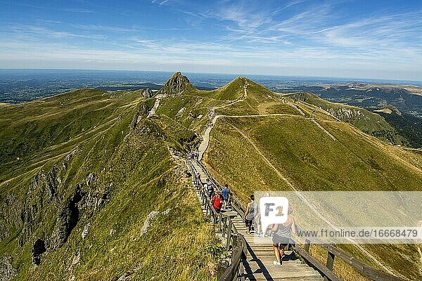 Hikers on way to top of Puy de Sancy Auvergne Volcanoes Natural Park Puy de Dome department Auvergne-Rhone-Alpes France Europe