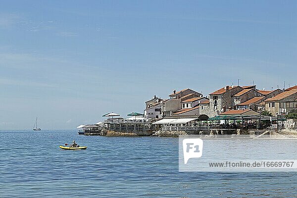 Bathing bay with old town Umag Istria Croatia Europe