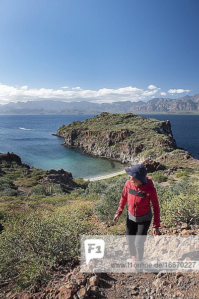 One woman hiking on a trail in Del Carmen Island at Loreto Bay