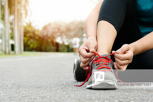 sport woman tying shoelace before running  outdoor activities