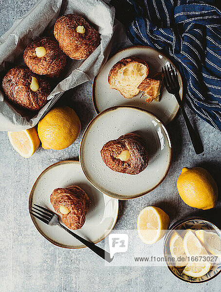 Overhead of plated lemon filled cruffins on a stone counter.