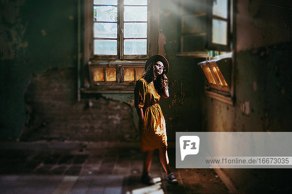 girl in derelict building with beautiful light