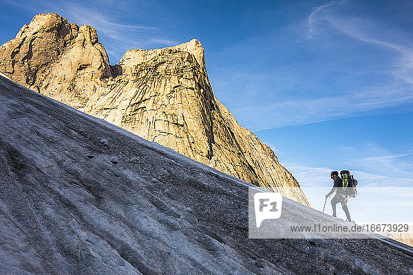 Mountaineer climbs glacier on approach to Mount Asgard.