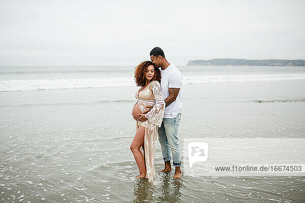 Mixed Race Couple Posing on Beach  Maternity