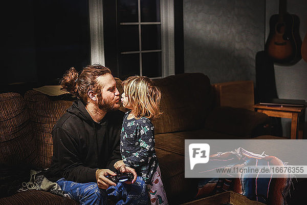 Little boy kissing his dad goodnight