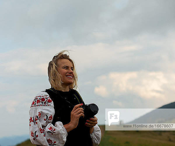 Fotografin im Sommer hoch in den Bergen in der ukrainischen Stickerei