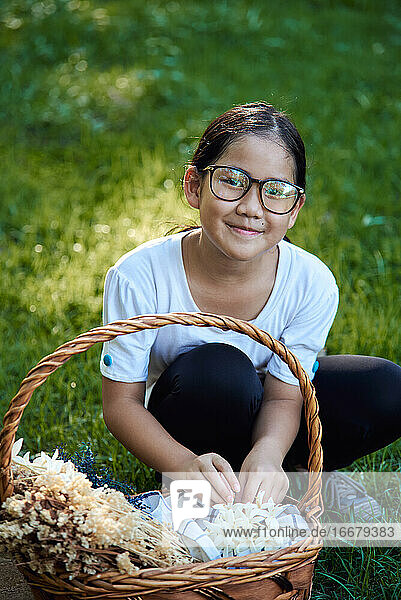 Portrait a girl picking flowers in the park