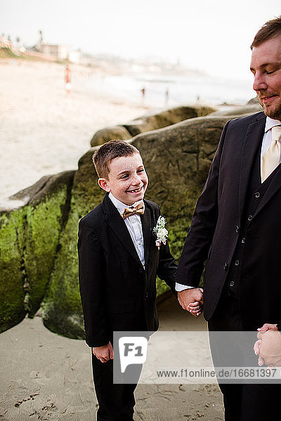 Nine Year Old Boy Holding Hands With Dad on Beach in San Diego