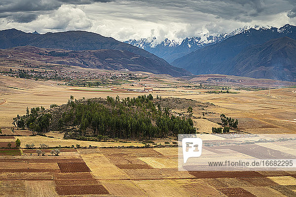 Fields in Sacred Valley with Andes mountains in background  Peru