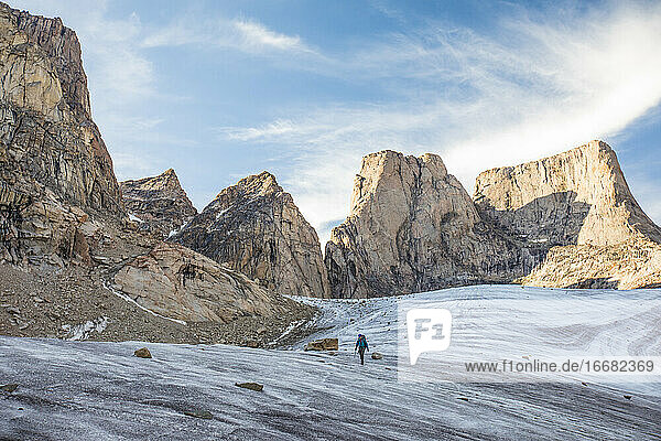 mountain climber traverses a glacier below Mount Asgard.