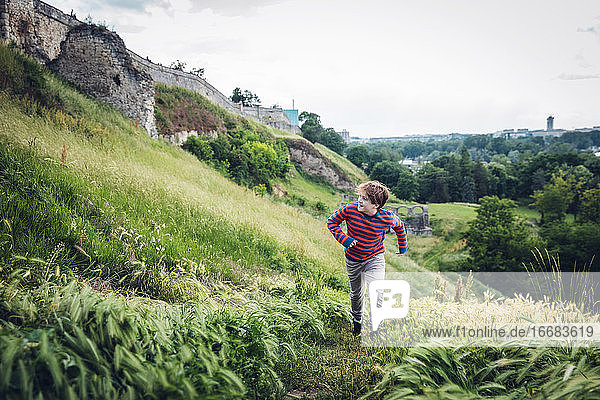 Boy Running Up A Grassy Hill in Belgrade  Serbia