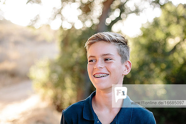 Portrait Of A Handsome Young Teen Looking Off And Smiling Outside