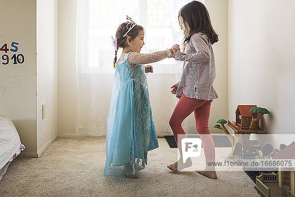 Barefoot 6 yr old dancing with 4 yr old sister in princess costume