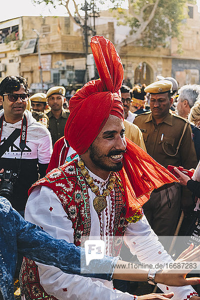Indian dancer dressed in colourful garment during the parade Jaisalmer Desert Festival